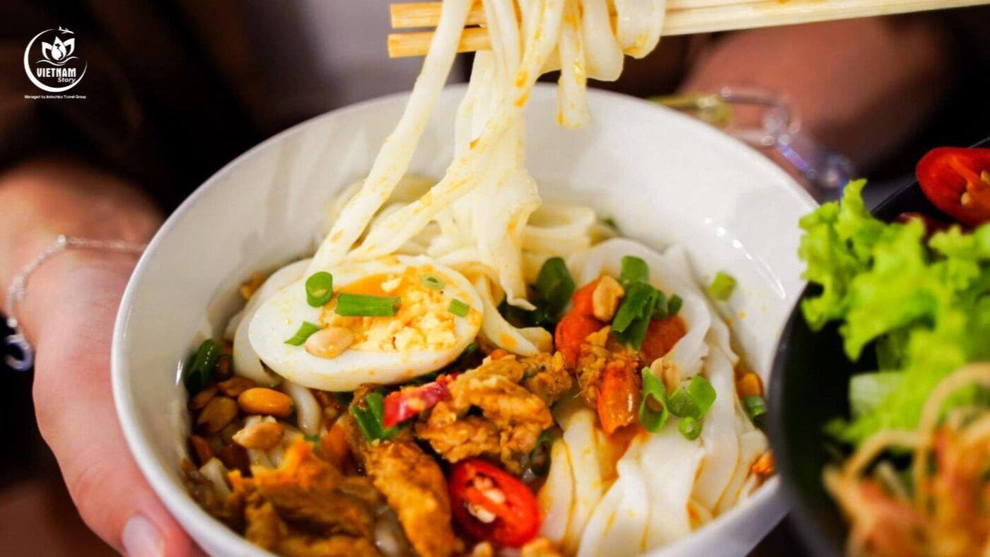A bowl of Mi Quang noodles, a specialty dish featured in the Da Nang travel guide for Indians. A bowl of Mi Quang noodles, a specialty dish featured in the Da Nang travel guide for Indians.